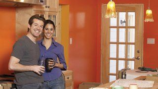 Happy couple in newly painted interior