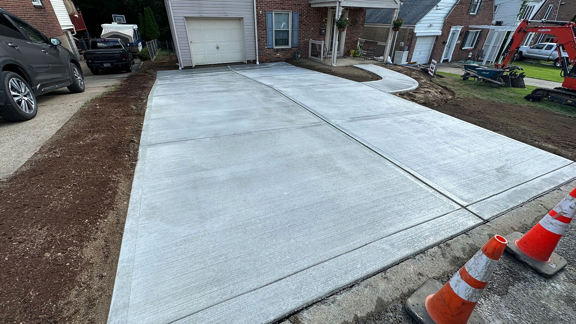 A concrete driveway is being built in front of a house.