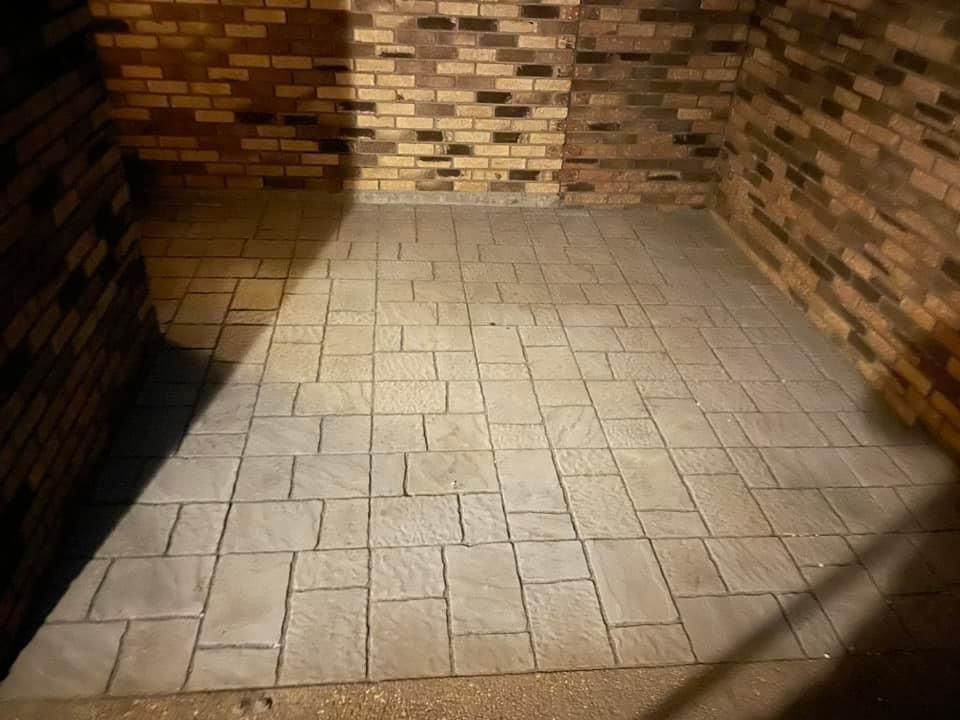 A room with a brick wall and a tiled floor