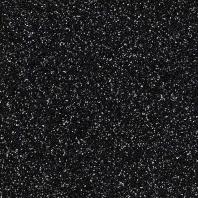 Dark speckled texture with scattered white flecks on a black background.