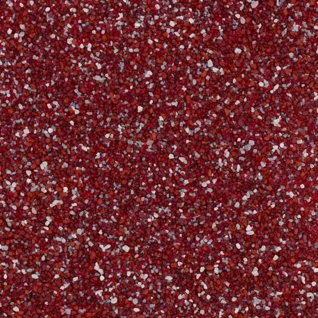Red and white speckled textured surface resembling glitter or granular material.