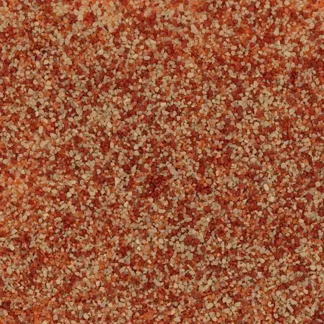 Close-up of a red and beige speckled textured surface.