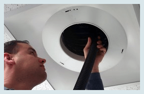 A man cleaning the air duct