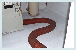 A red air duct hose in the floor