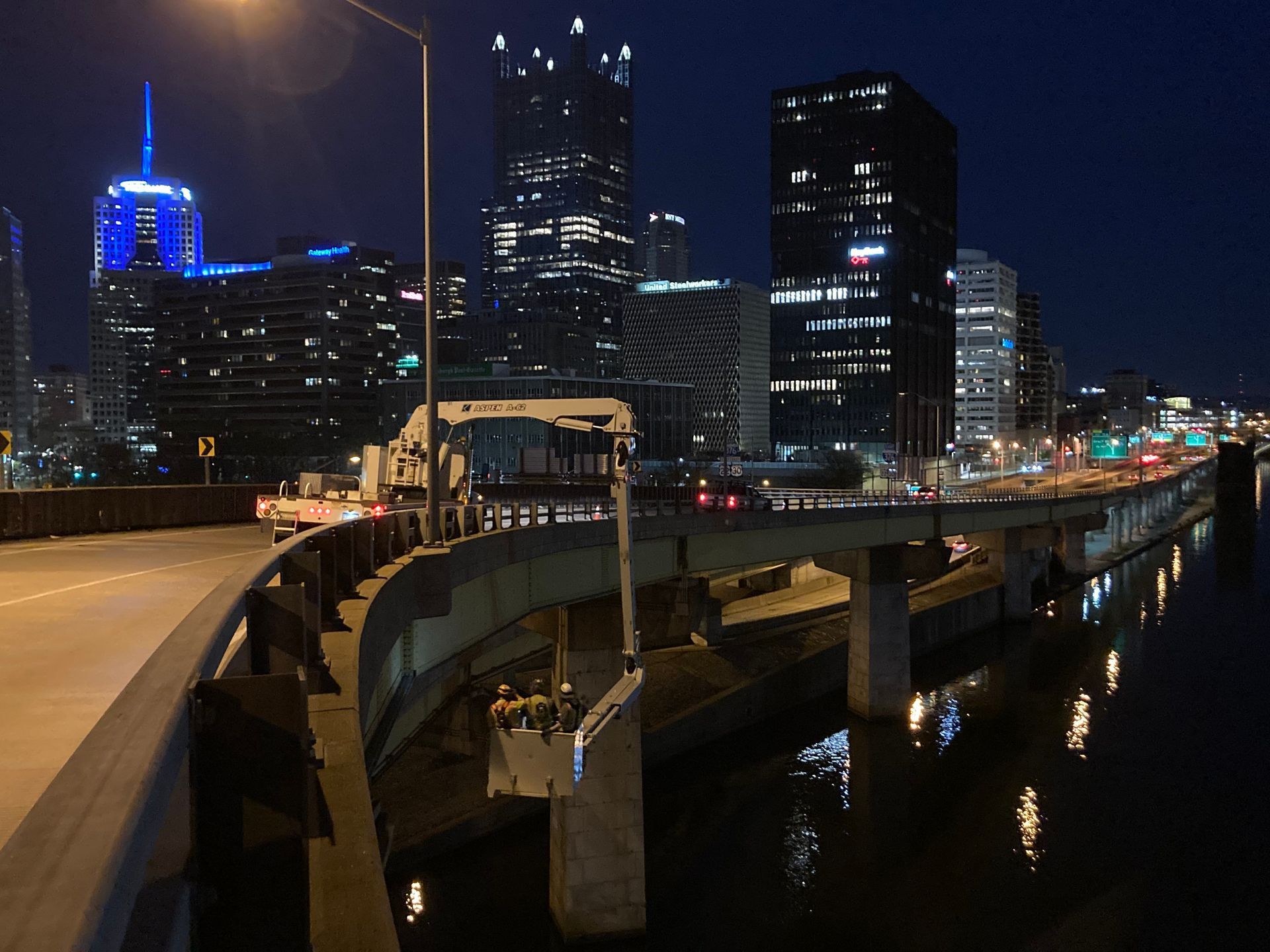 A bridge over a body of water with a city in the background