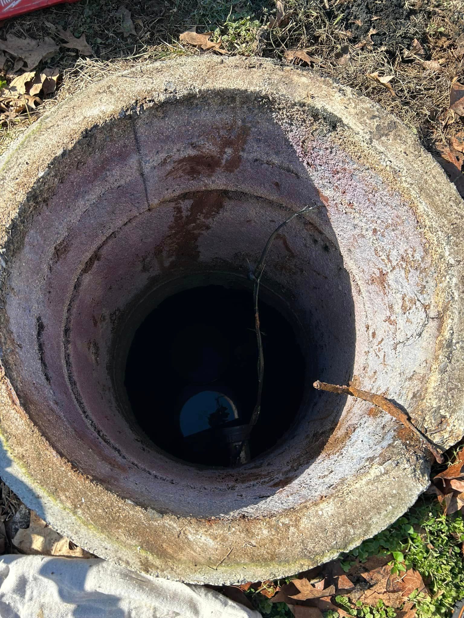a manhole cover with a hole in the middle of it .