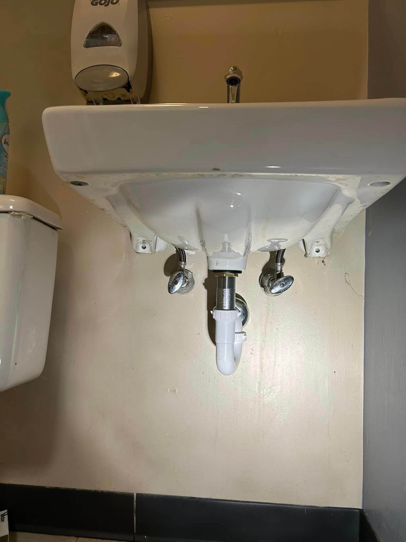 a bathroom sink with a toilet next to it .