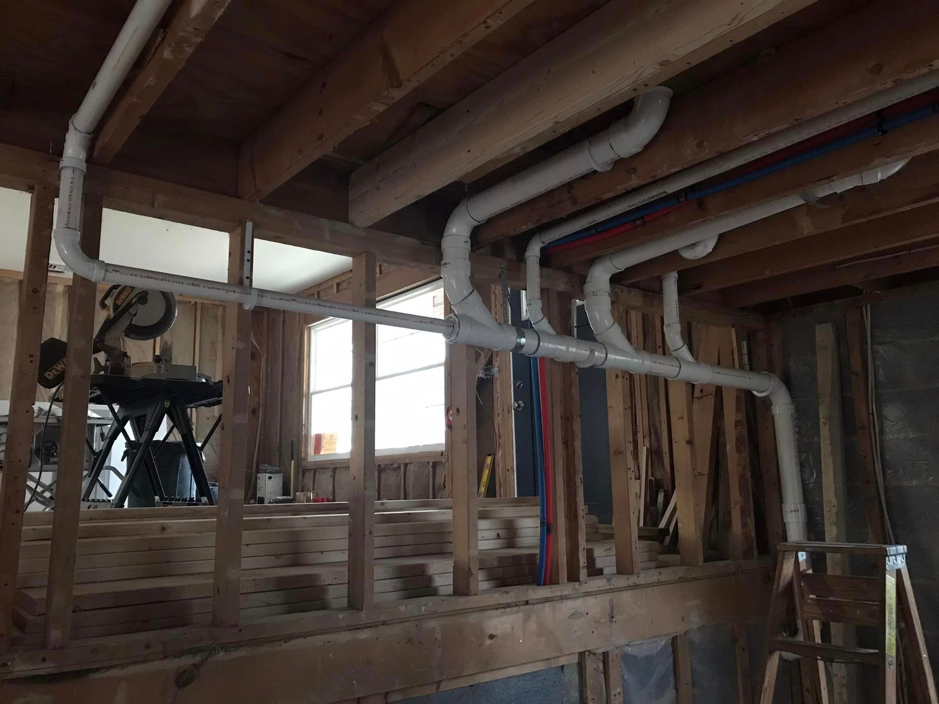 a room with a lot of pipes hanging from the ceiling .
