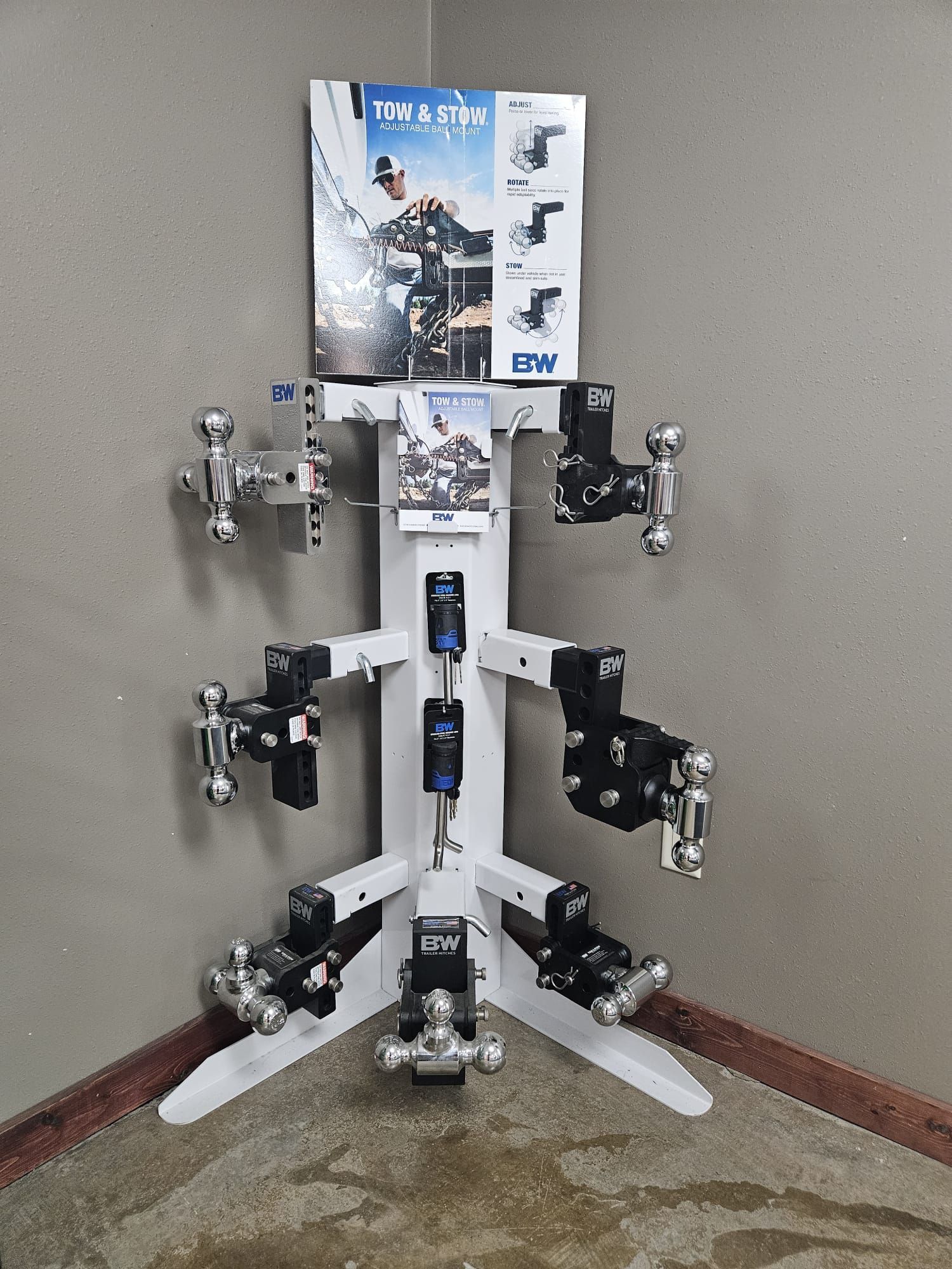 A display of trailer hitches is sitting in a corner of a room.