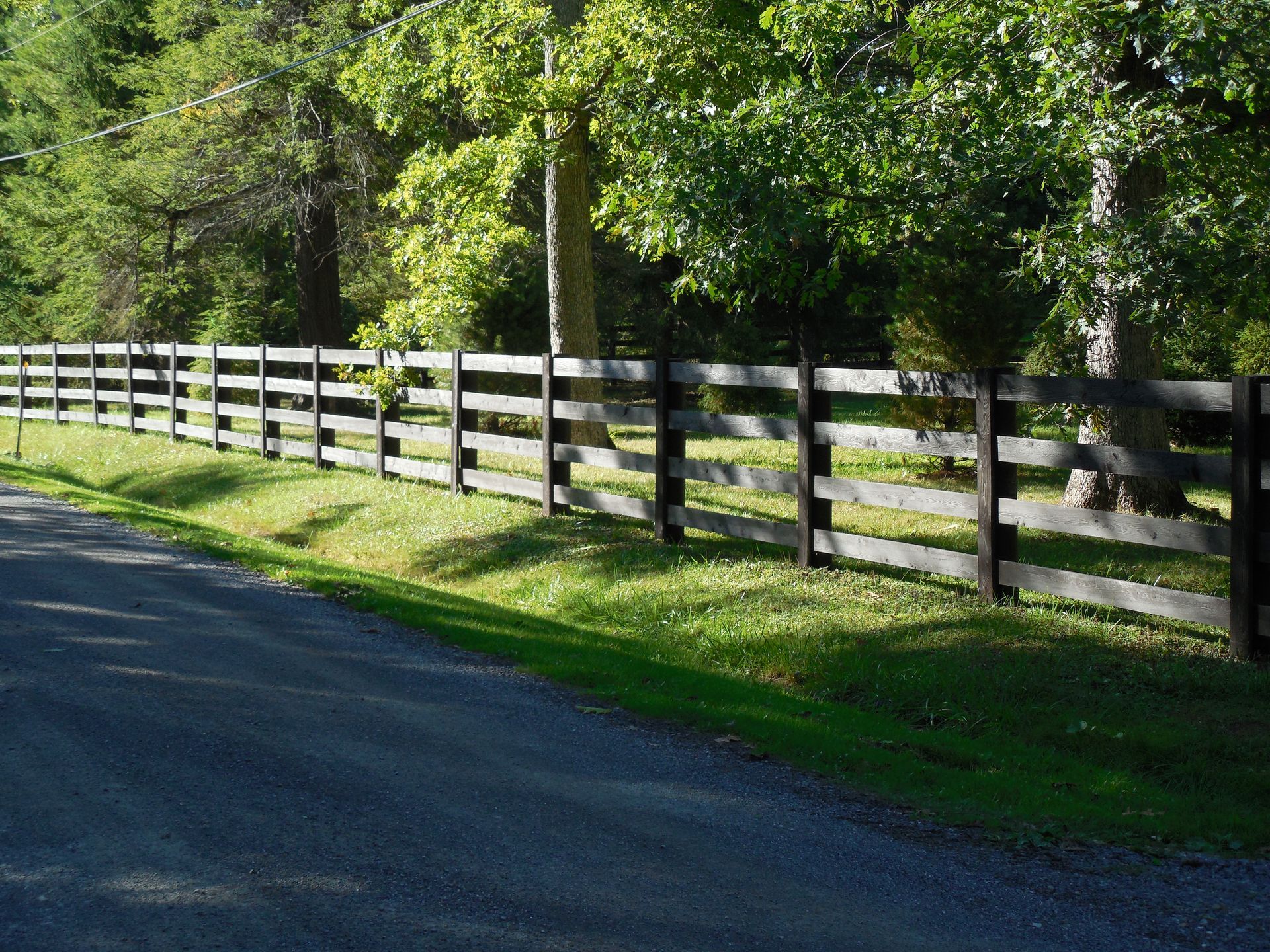A wooden fence along the side of a road