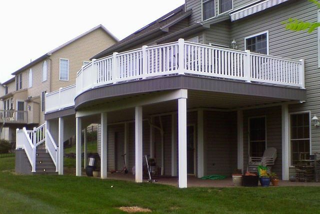 A large house with a large deck and stairs