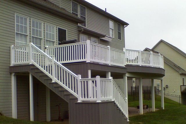 A house with a deck and stairs leading up to it