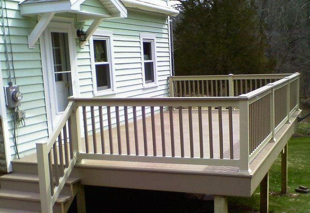 A house with a deck and stairs in front of it