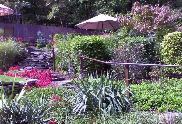 A garden with a white umbrella in the middle