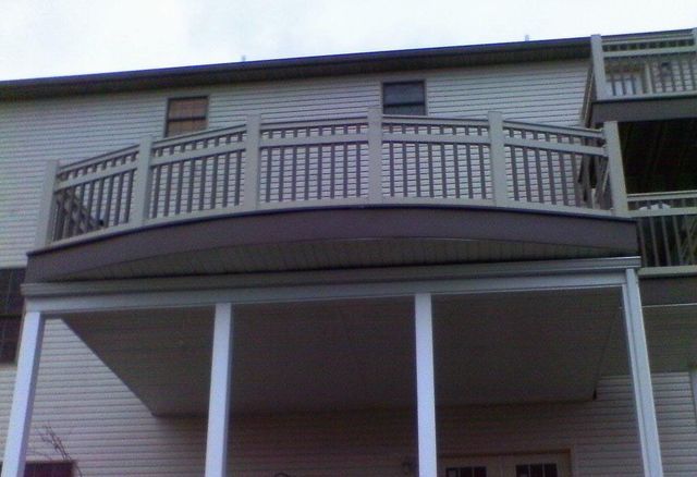 A balcony on the side of a house with a railing