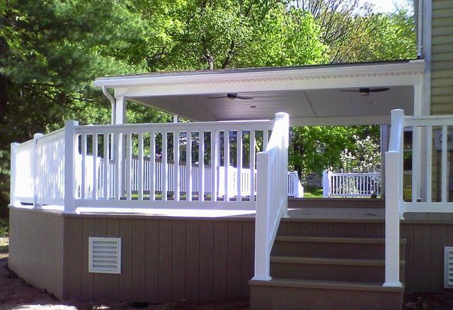 A white deck with stairs leading up to it