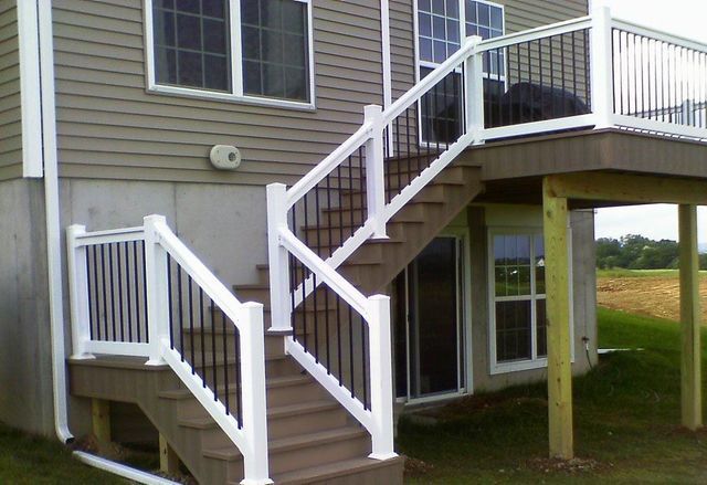 A house with a deck and stairs leading up to it