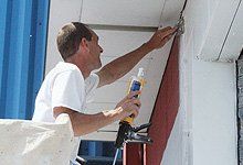 Man caulking the wall