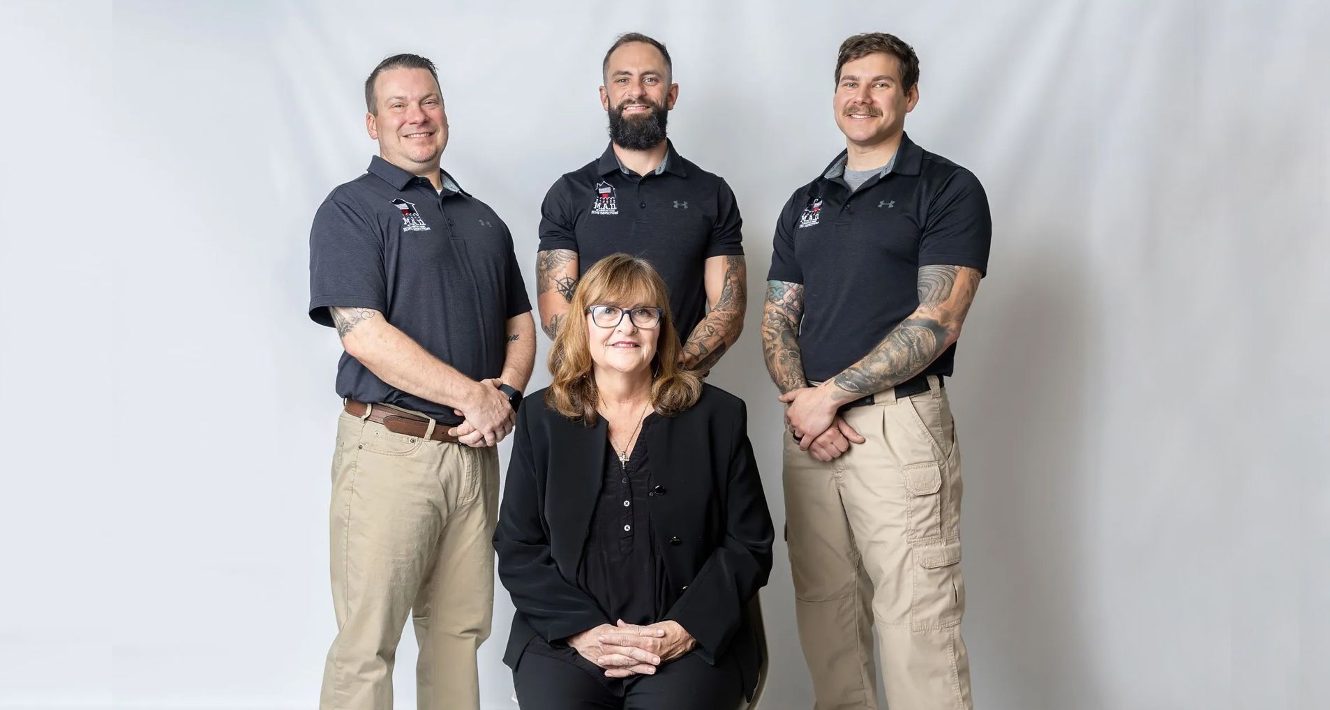 Home inspection report with pen, keys, flashlight, and electrical plug on a table.