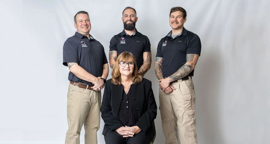 Person holding a digital thermometer, testing water temperature in a bathroom sink.