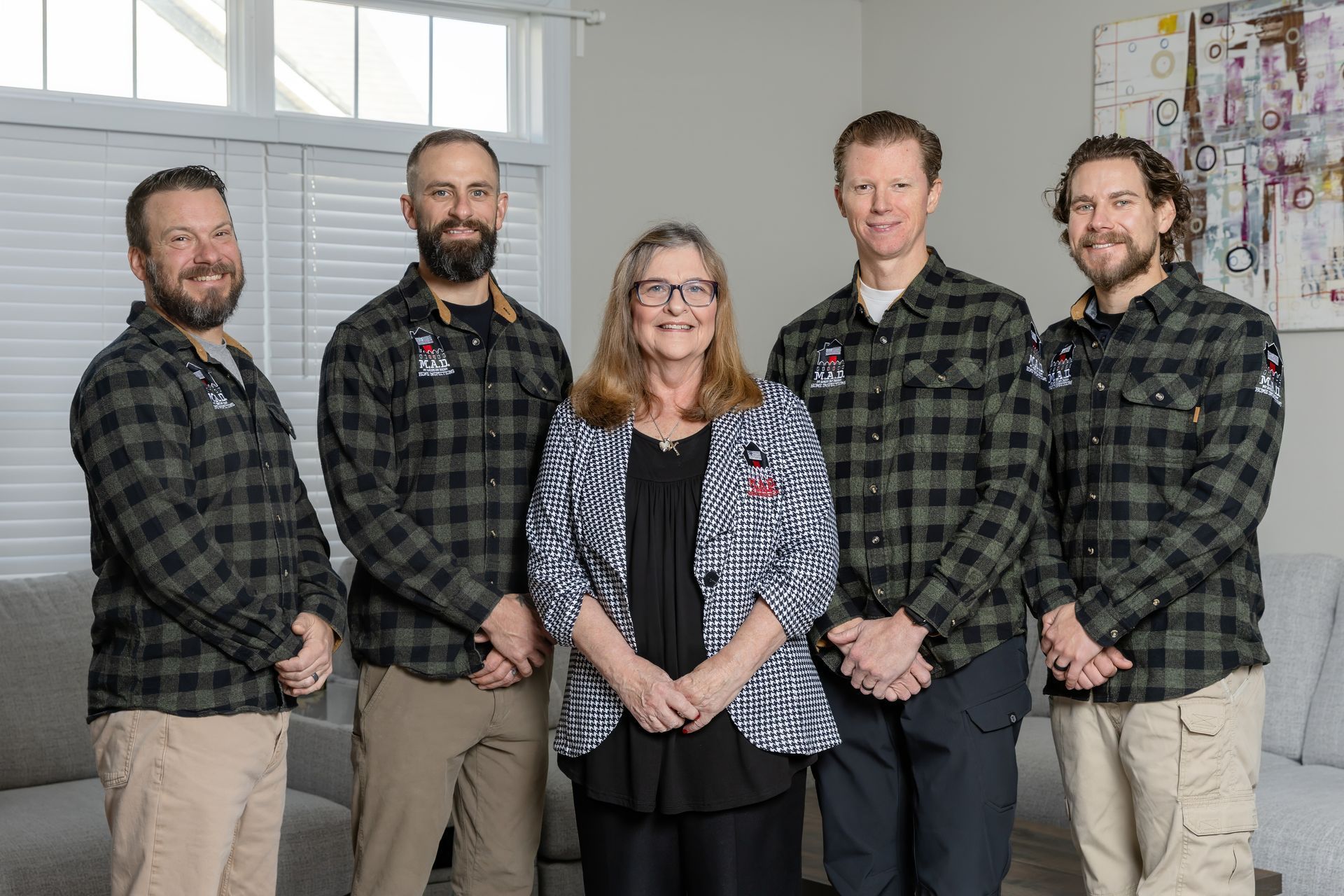 Person holding a digital thermometer, testing water temperature in a bathroom sink.