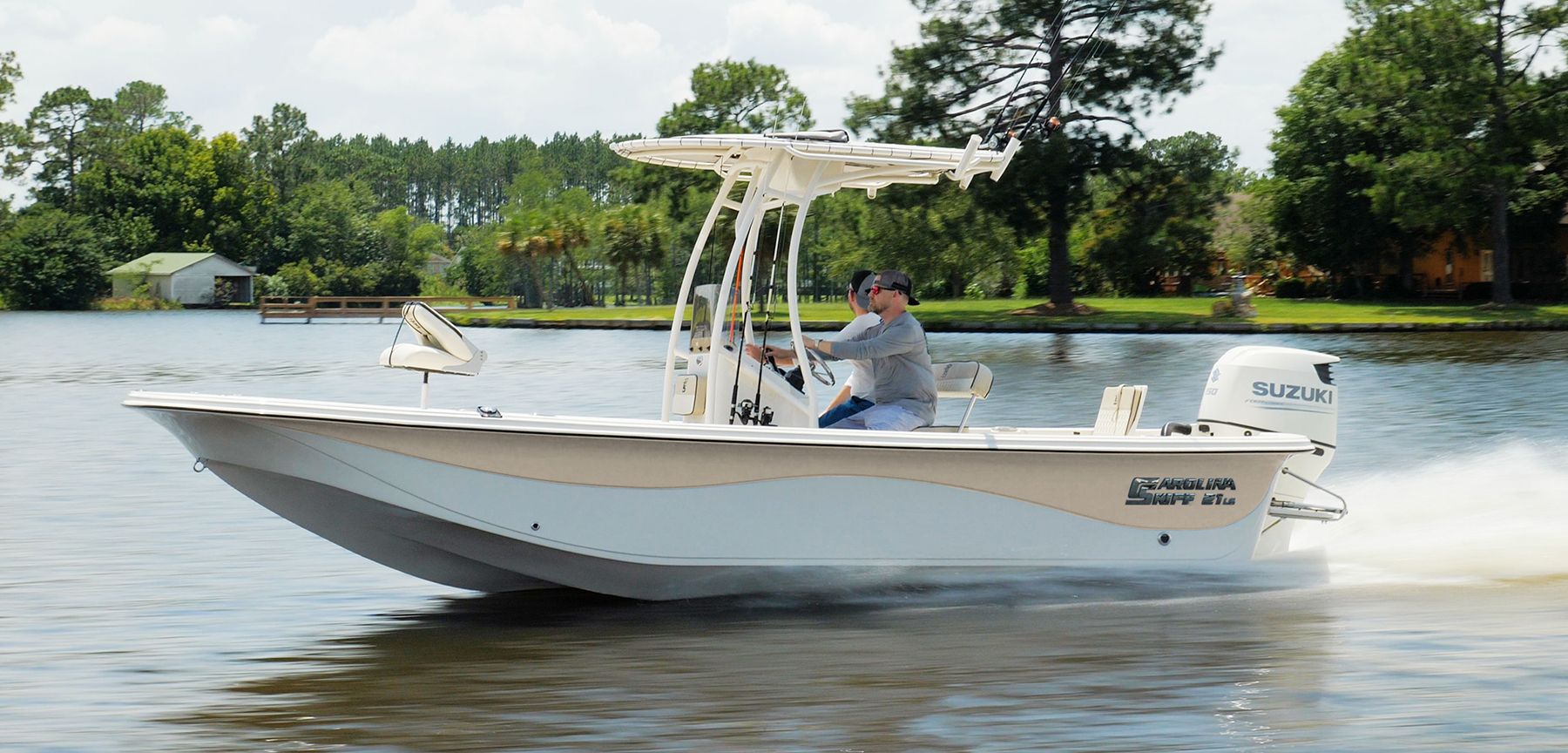 Pontoon boat docked on a lake with beige seating and black trim.