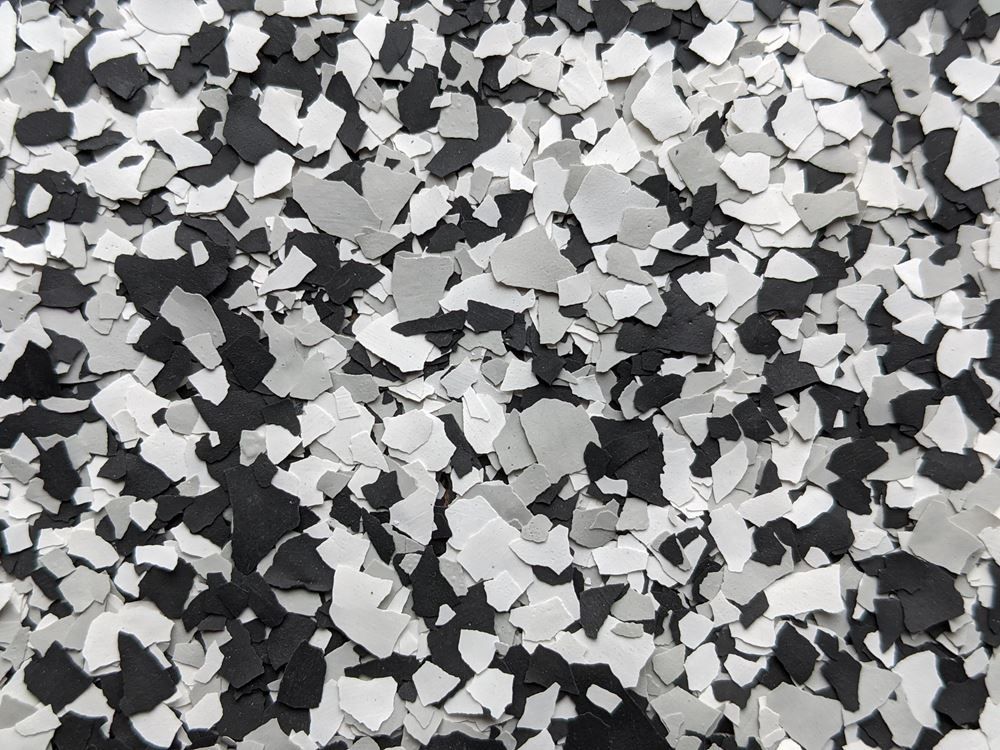 Black, white, and gray camouflage-like speckled pattern texture