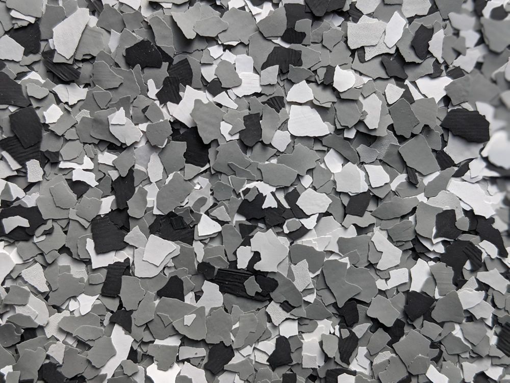 Scattered gray and black rock fragments filling the frame, creating a textured abstract pattern