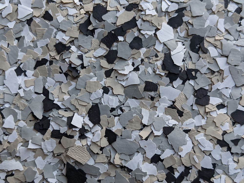 Close-up of scattered gray, black, and white gravel stones forming a rough textured surface