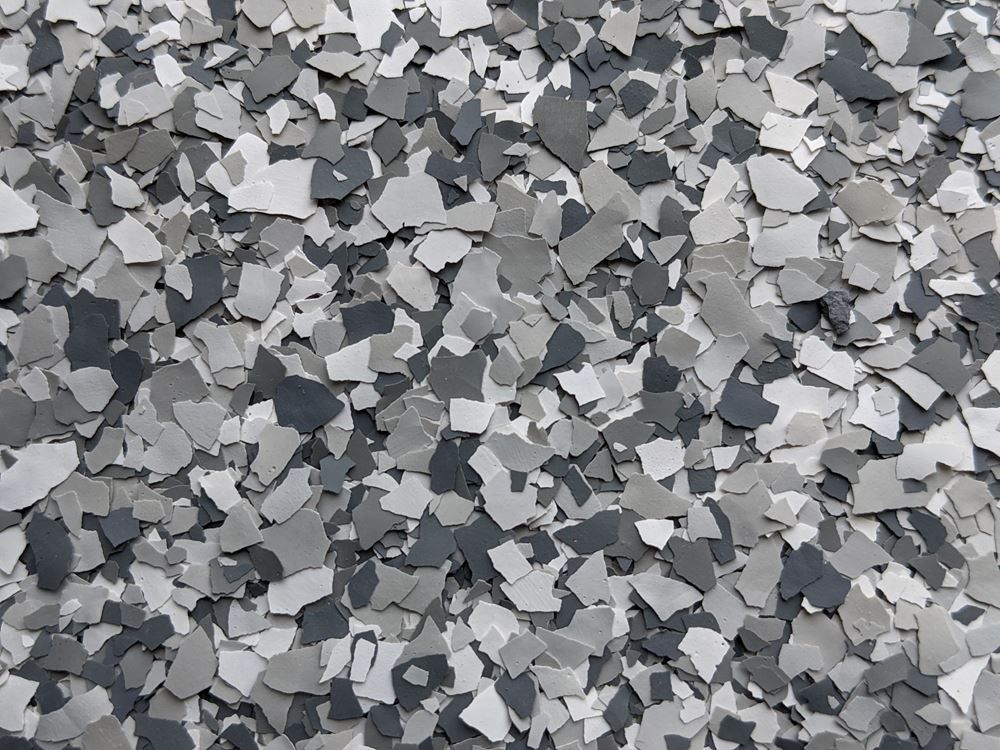Gray and black gravel stones scattered densely in a textured pattern