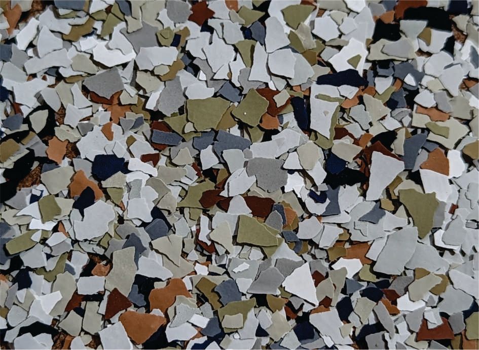 Close-up of a speckled terrazzo surface with white, gray, tan, and brown chips