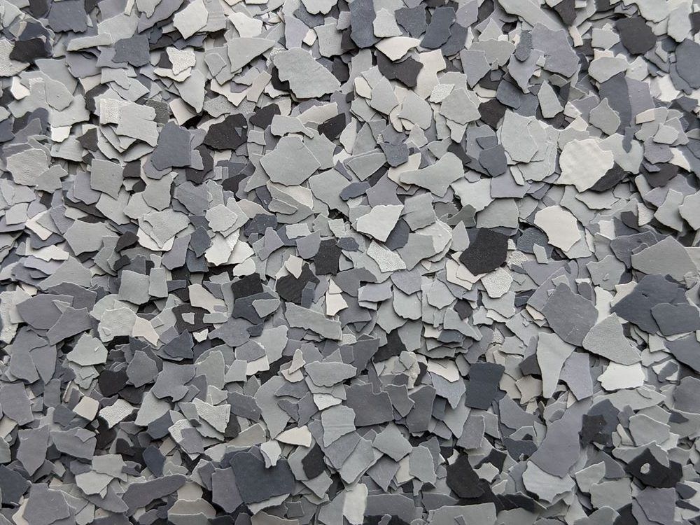 Gray and black crushed stone or gravel scattered in a textured pile