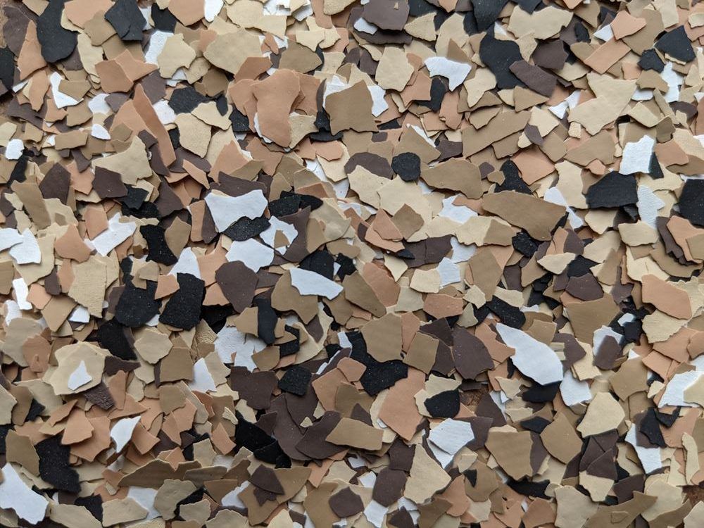 Pile of multicolored broken tile and stone pieces scattered across a surface