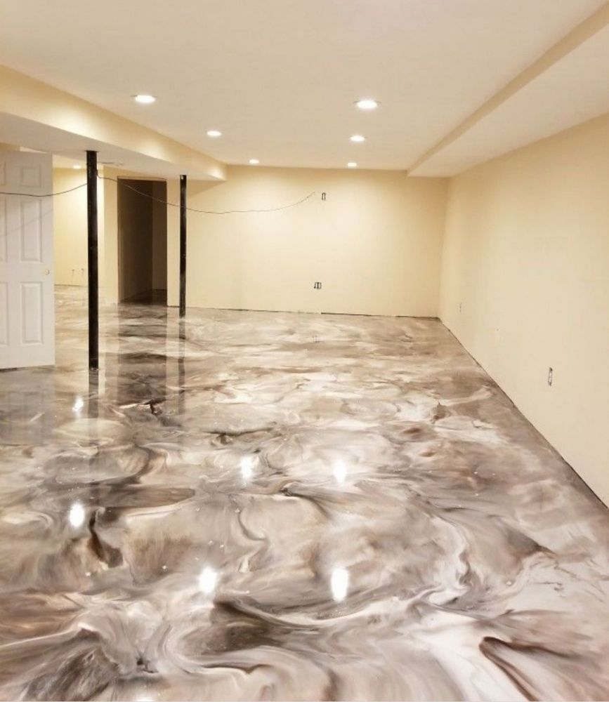 Empty room with glossy gray-white marbled floor, beige walls, recessed lights, and open doorways