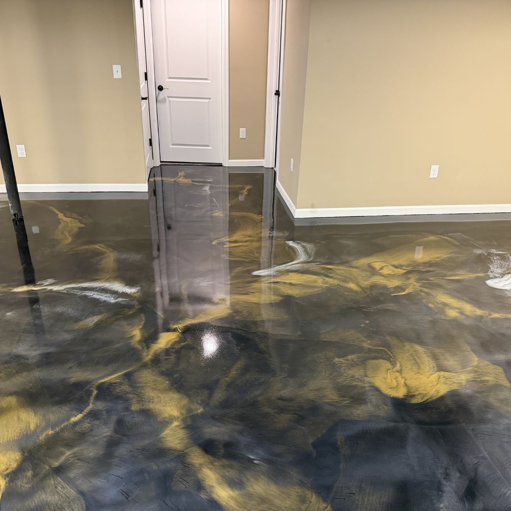 Empty room with glossy black-and-gold marbled floor and closed white doors.