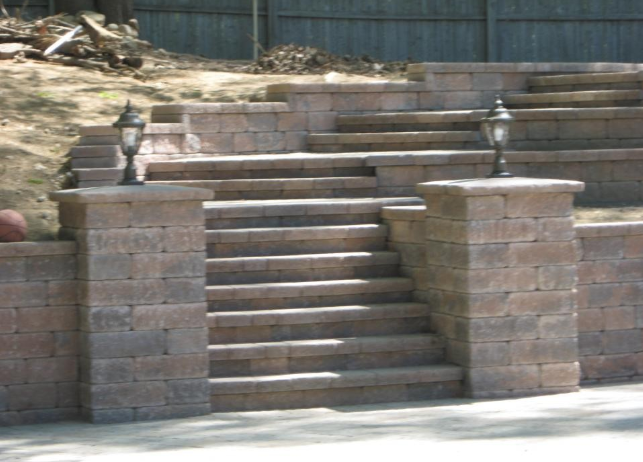 Brick staircase with retaining walls and lanterns.
