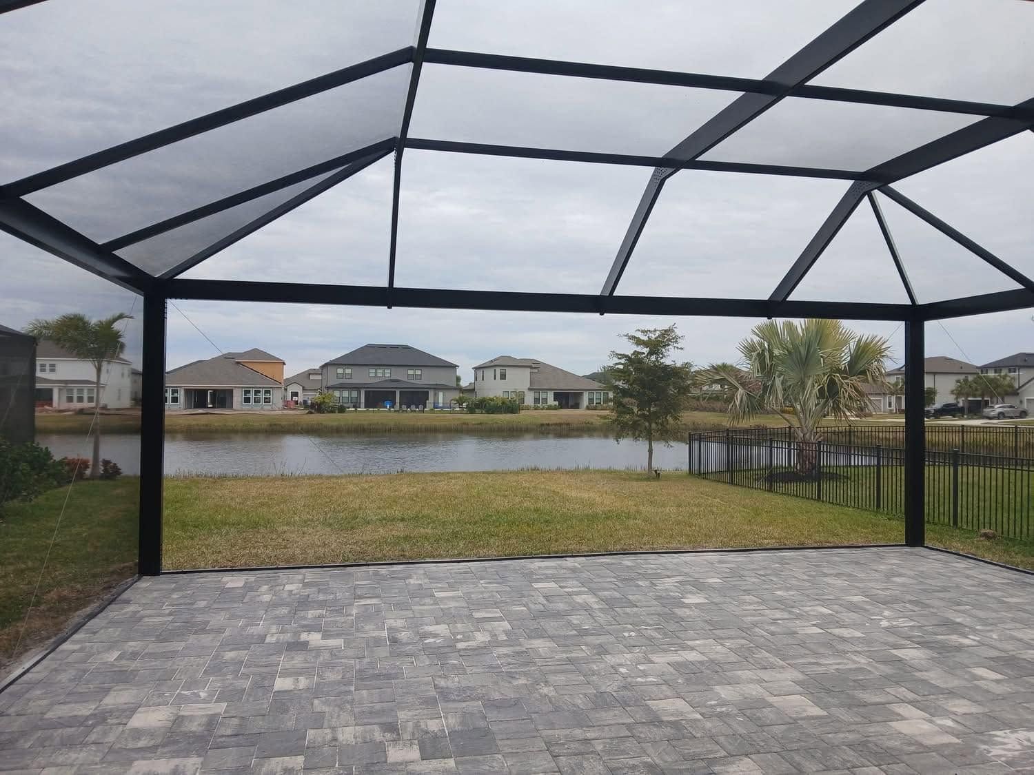 Screened patio overlooking a lake and houses across the water