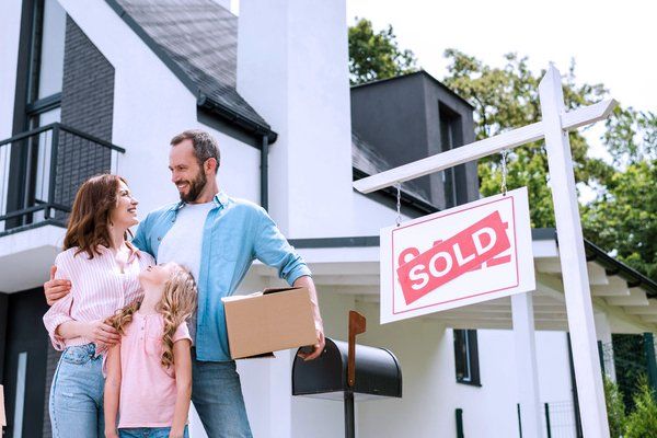 Happy couple outside their house