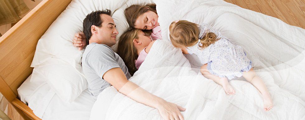 Family laying in bed
