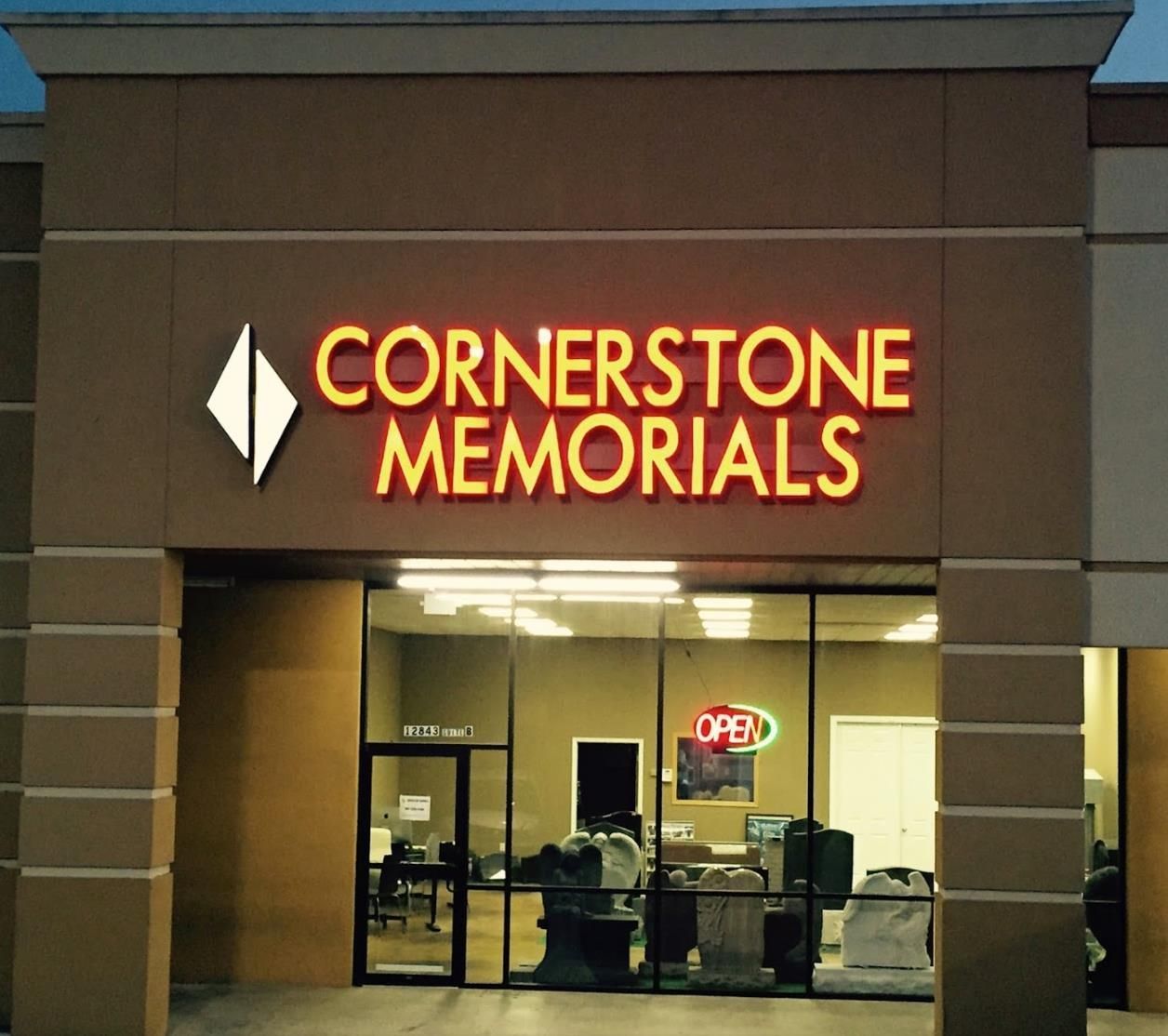 Cornerstone memorials store front with a neon sign that says open