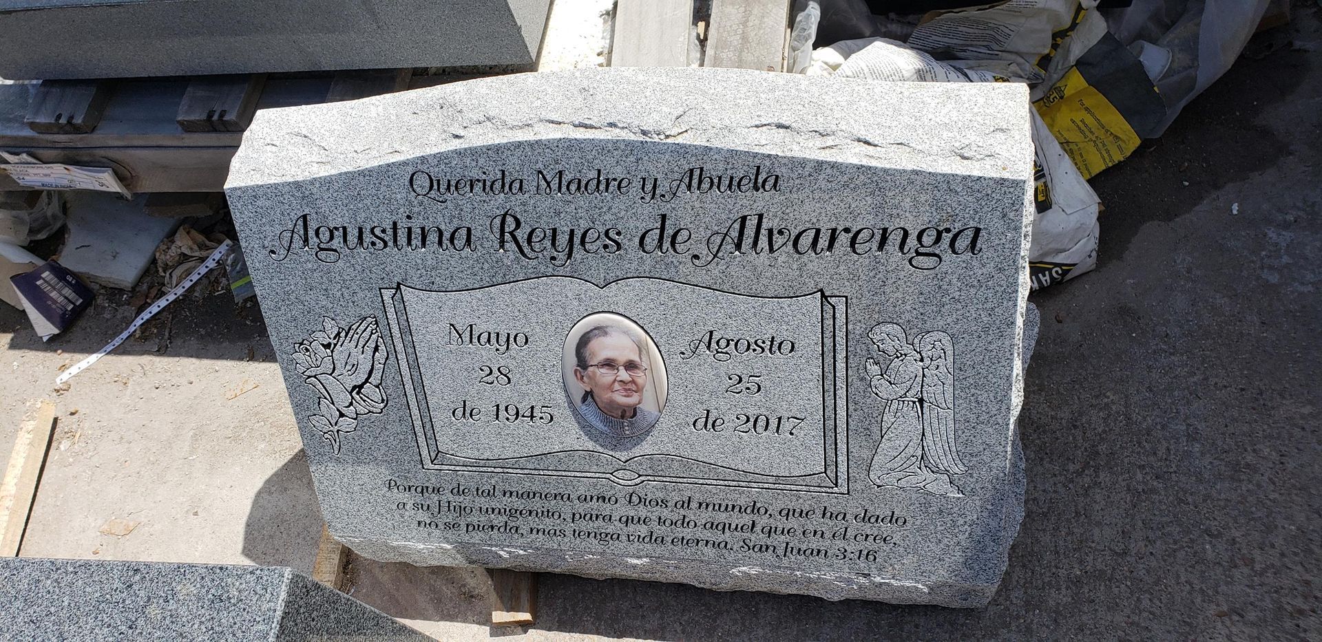 A gravestone with a picture of a woman on it