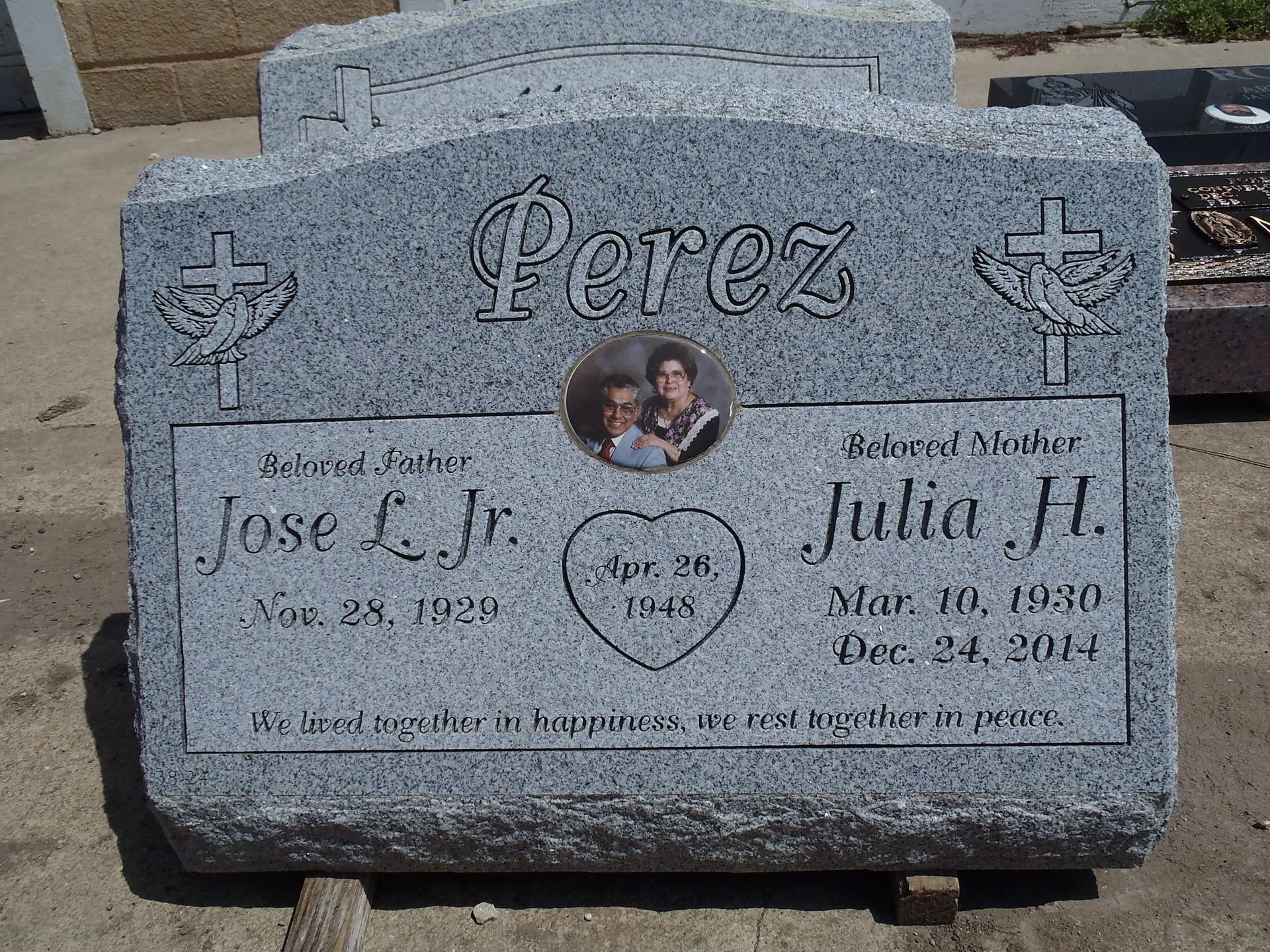 A headstone with a Perez written on the top of a couple picture