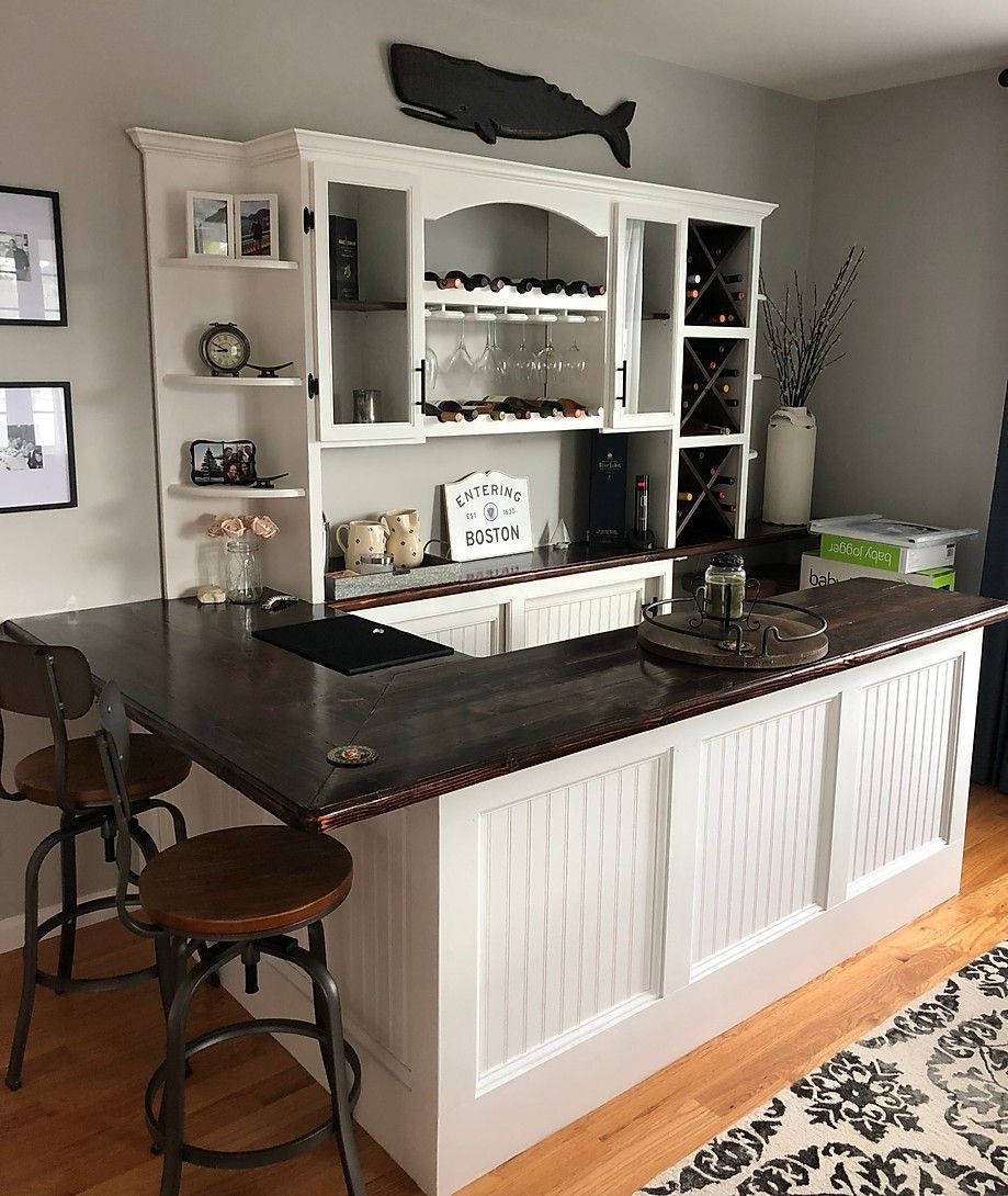 White and brown home bar with stools and whale decoration.