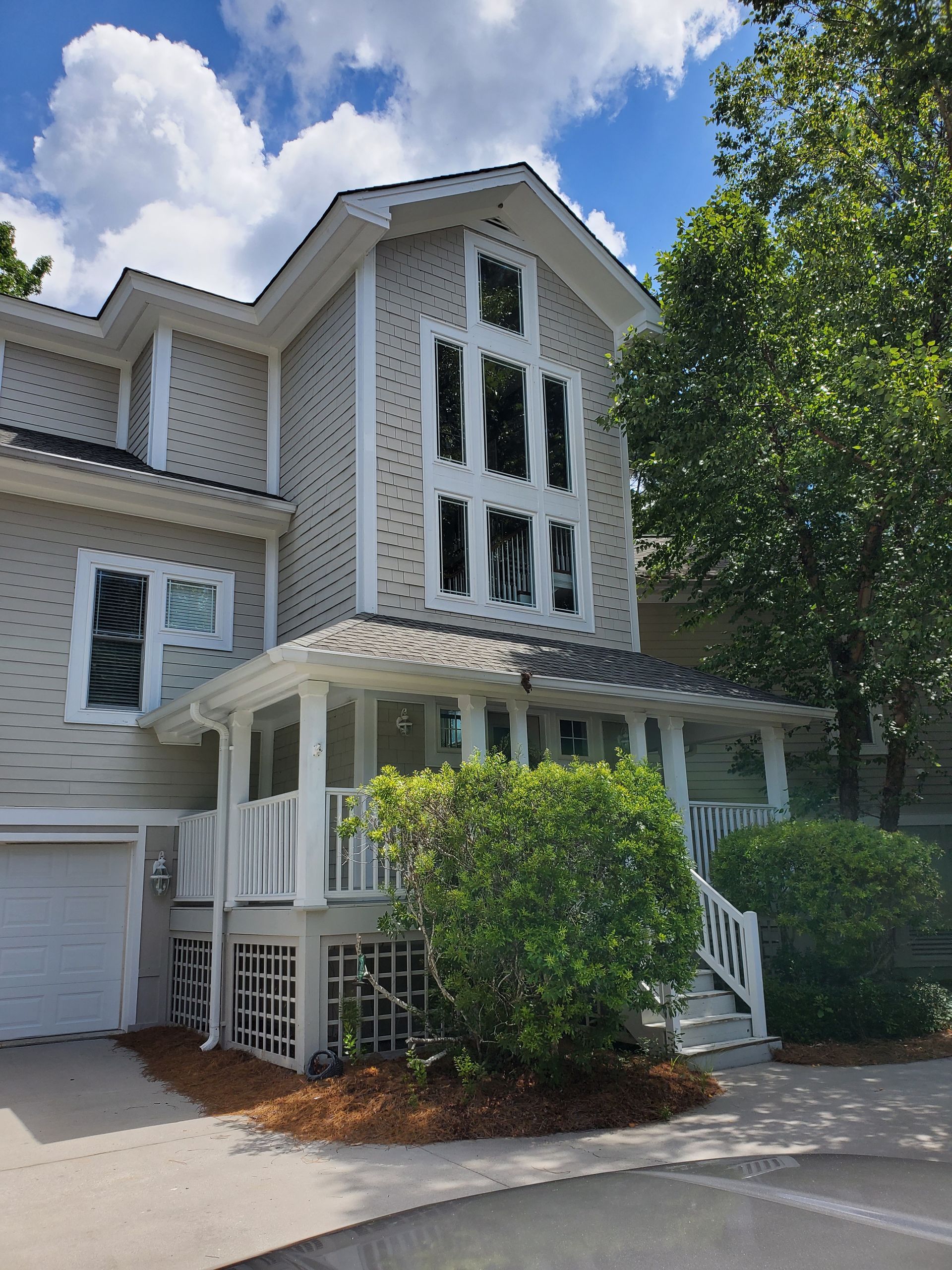 A large house with a large porch and stairs