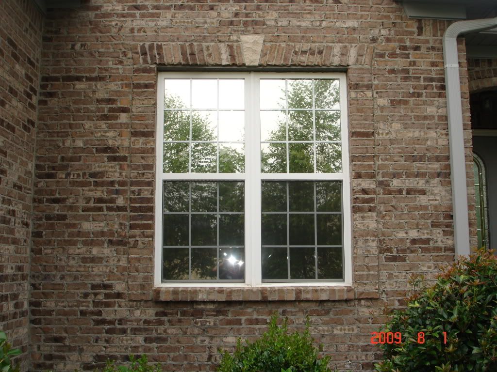 A brick building with a white window on it