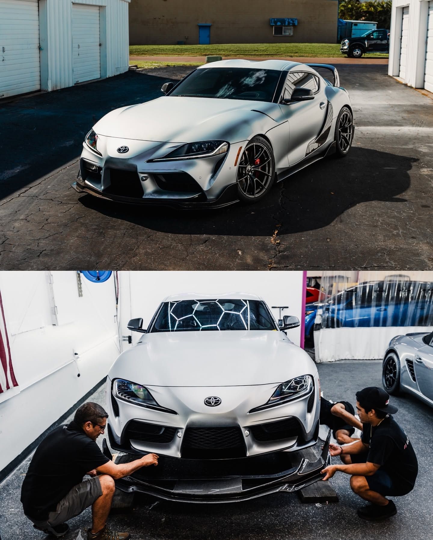 Silver sports car in a garage, with two people crouched at the front adjusting a bumper splitter.