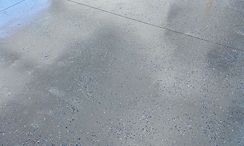 A close up of a concrete floor with a lot of small dots on it.