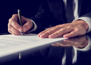 Signing a document in black desk