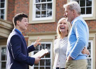 Realtor Showing Mature Couple Around House For Sale