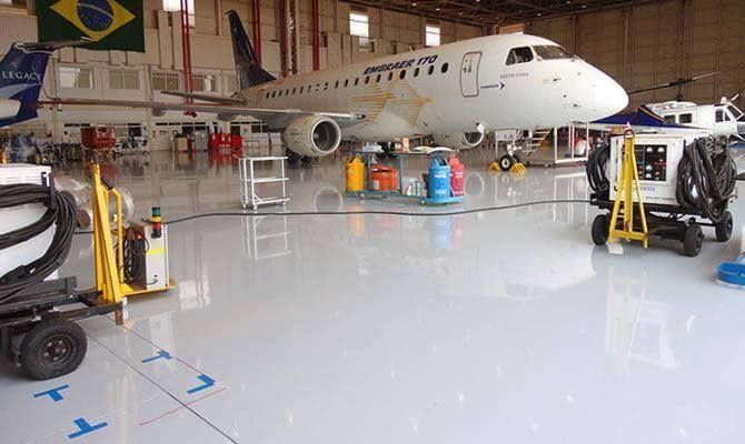 A large passenger jet is parked in a hangar.